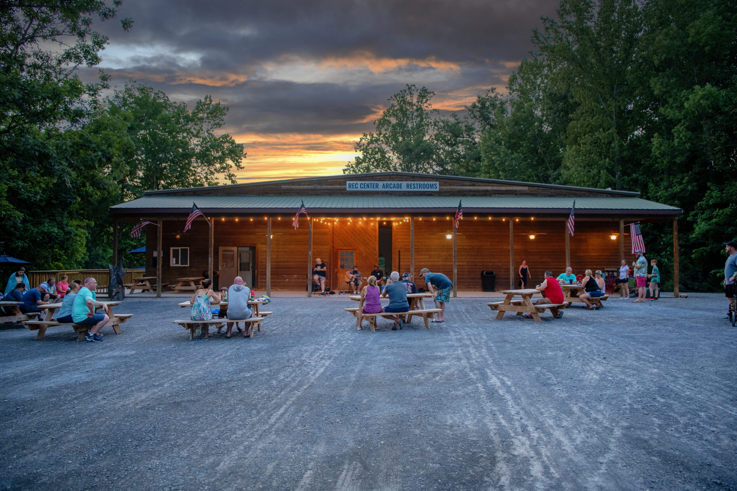 Guests sitting at sunset listening to live music performer