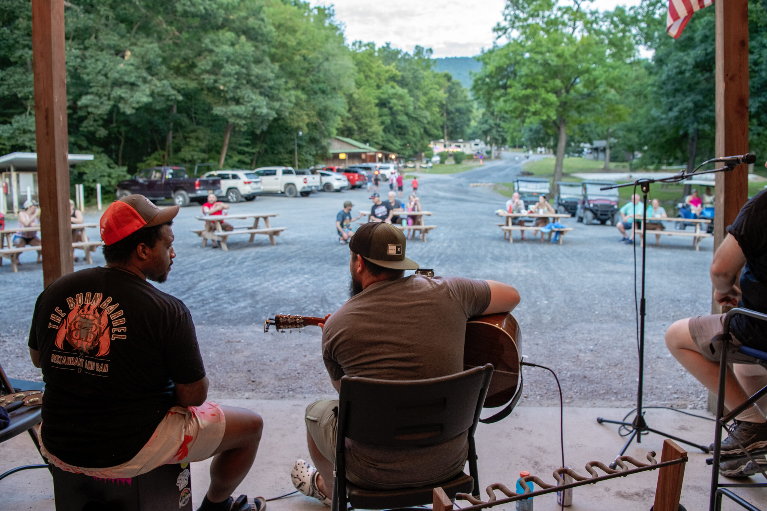 Guitar Player playing music with guests gathered around